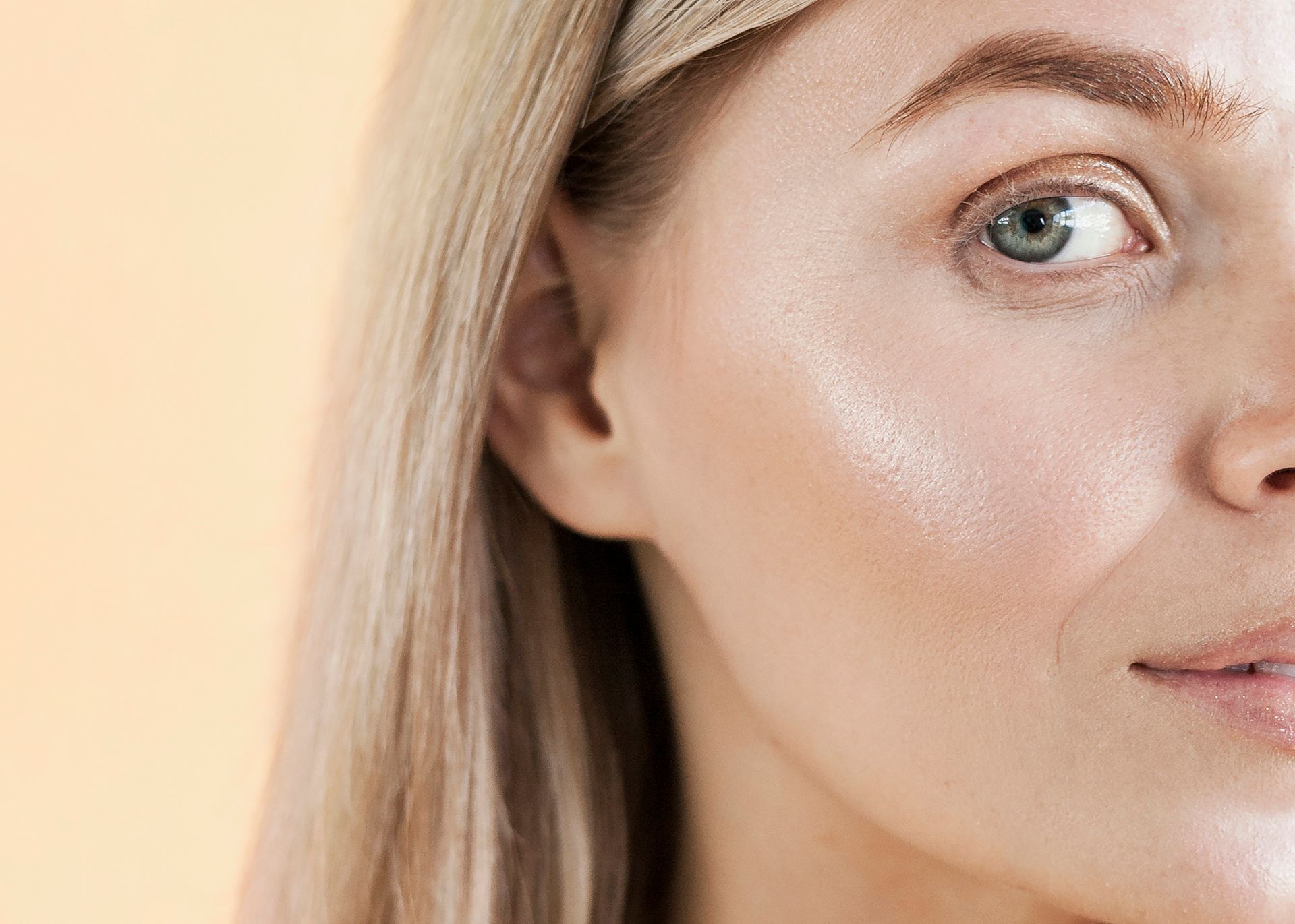 A close up of a woman 's face with a blue eye.