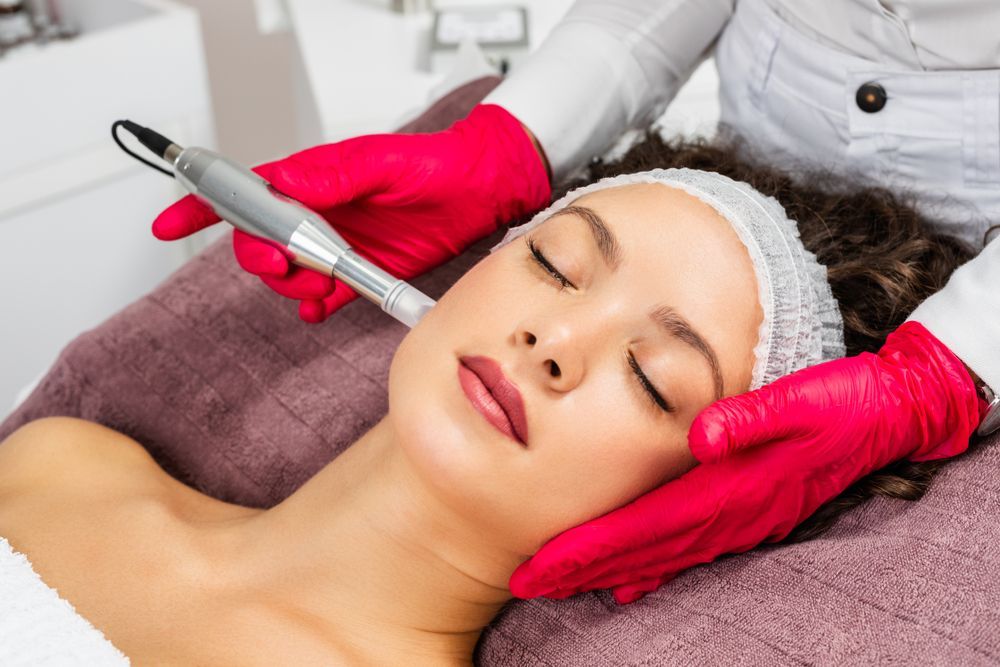 A woman is getting a facial treatment at a beauty salon.