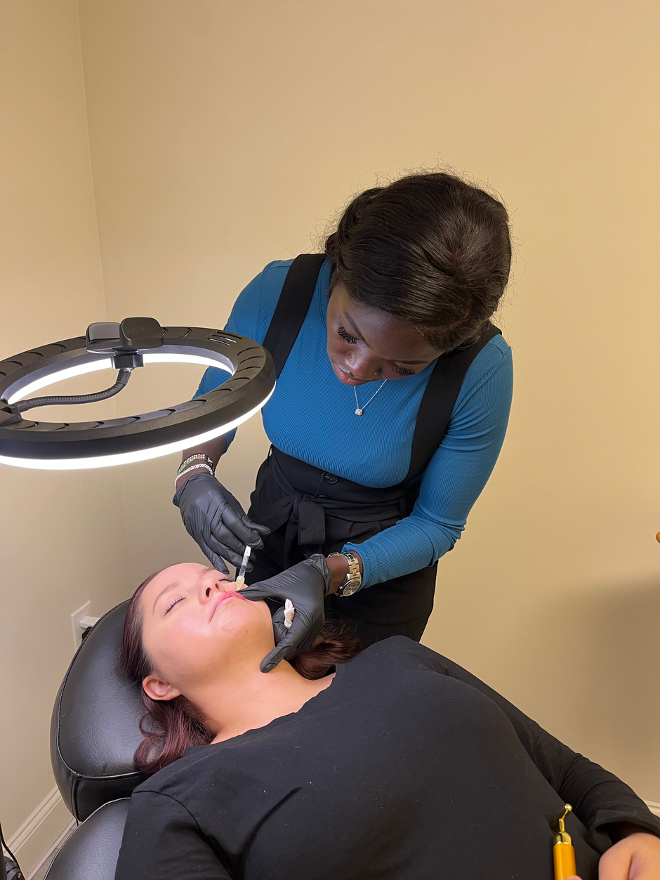 A woman is getting a botox injection in her face.