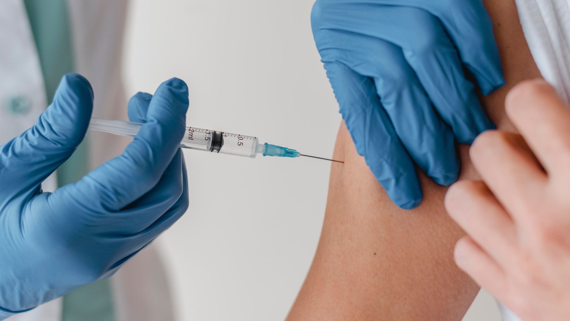 A person is getting a vaccine from a doctor.