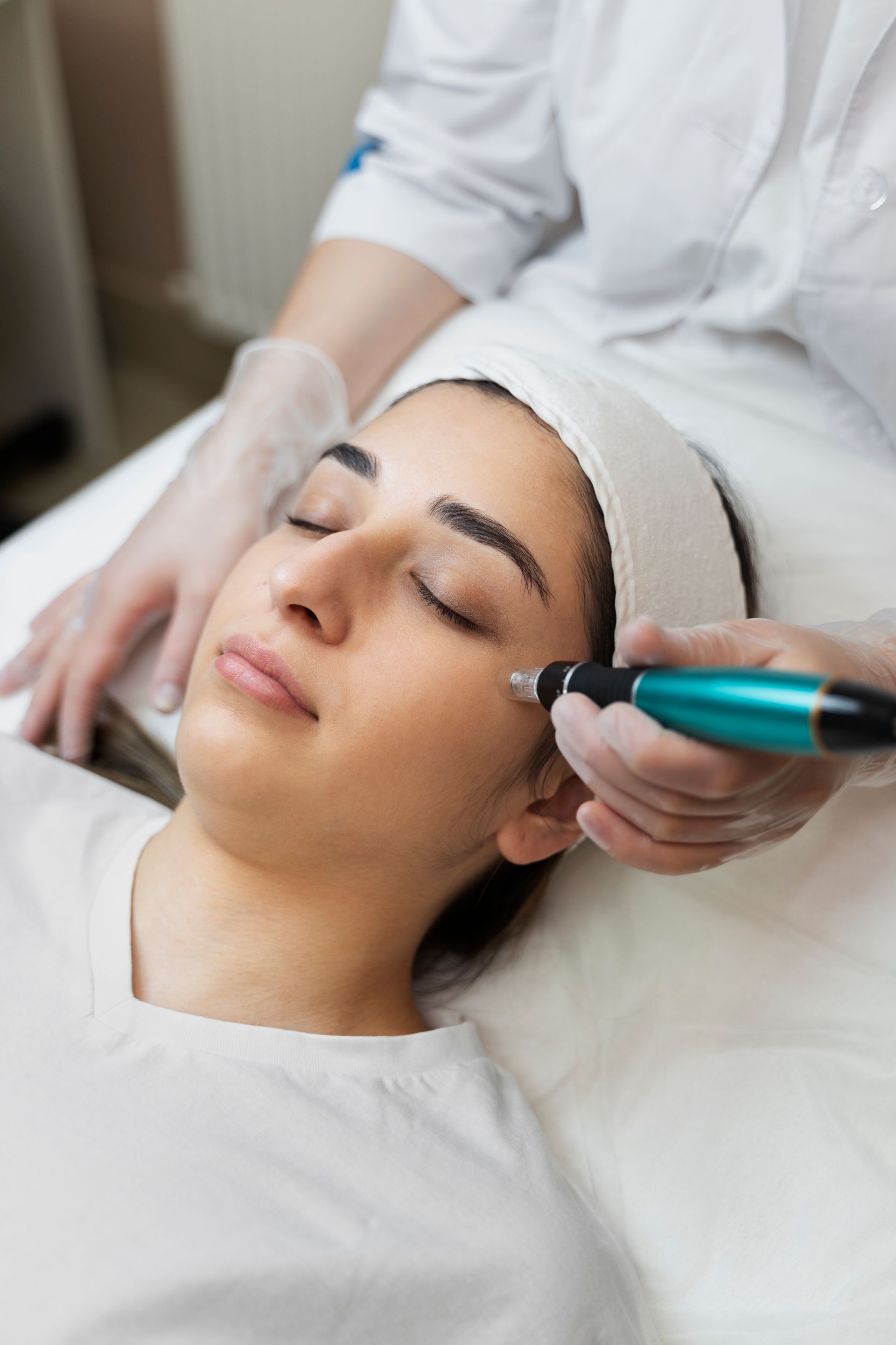 A woman is getting a facial treatment at a beauty salon.