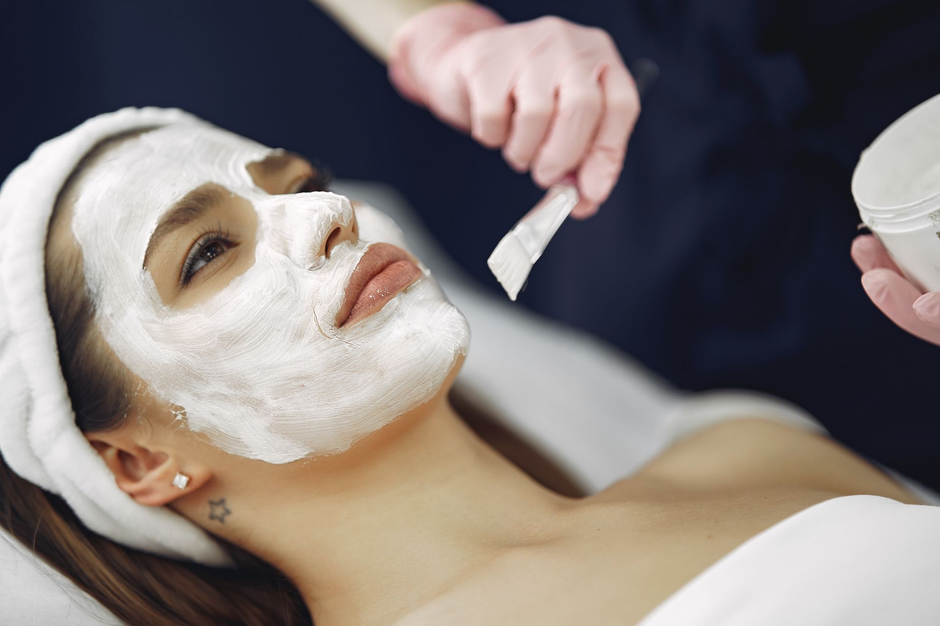 A woman is getting a facial treatment at a spa.