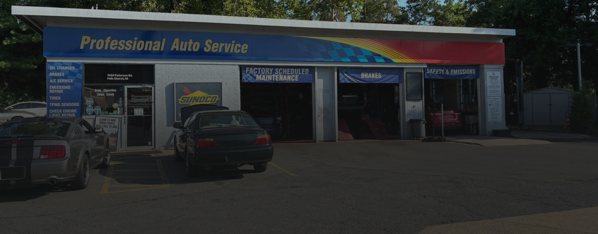 Professional Auto Service garage with cars parked outside and blue-red signage