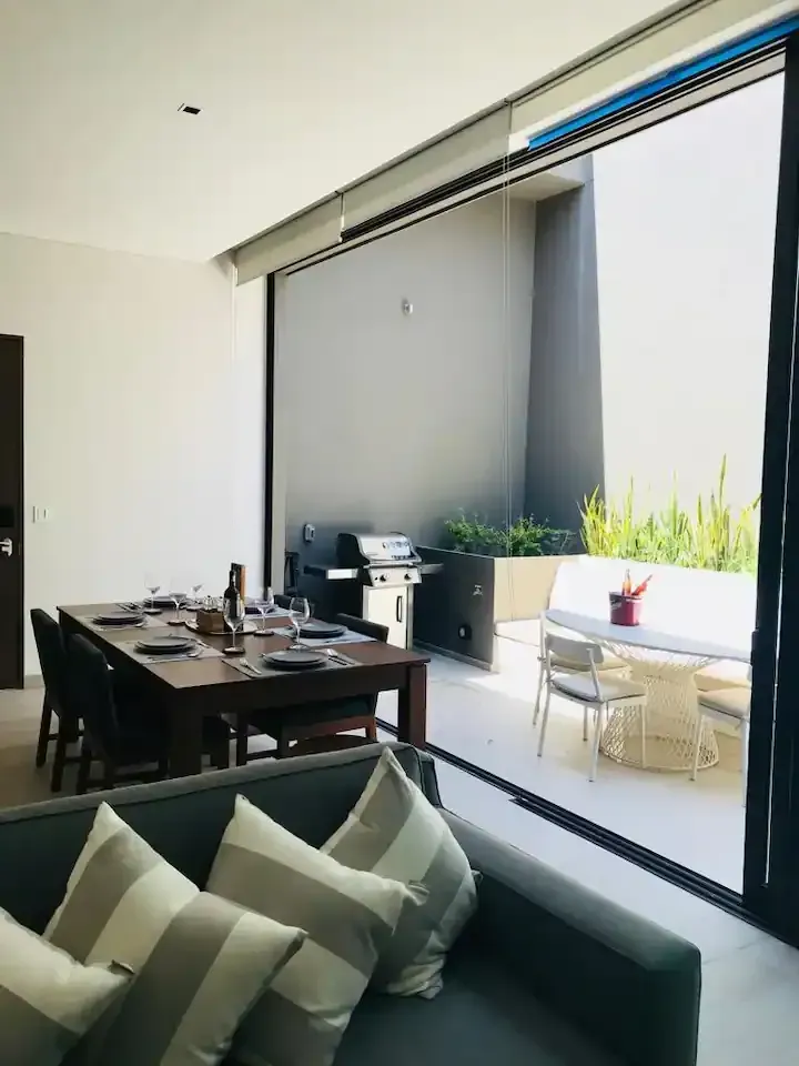 A living room with a couch and a table and chairs