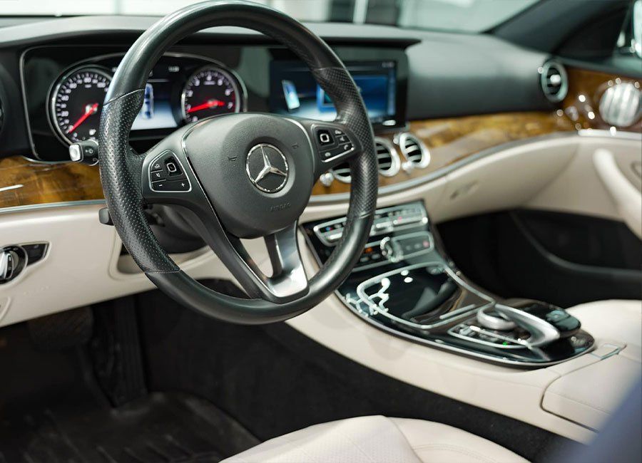 the interior of a mercedes benz car with a steering wheel and dashboard .