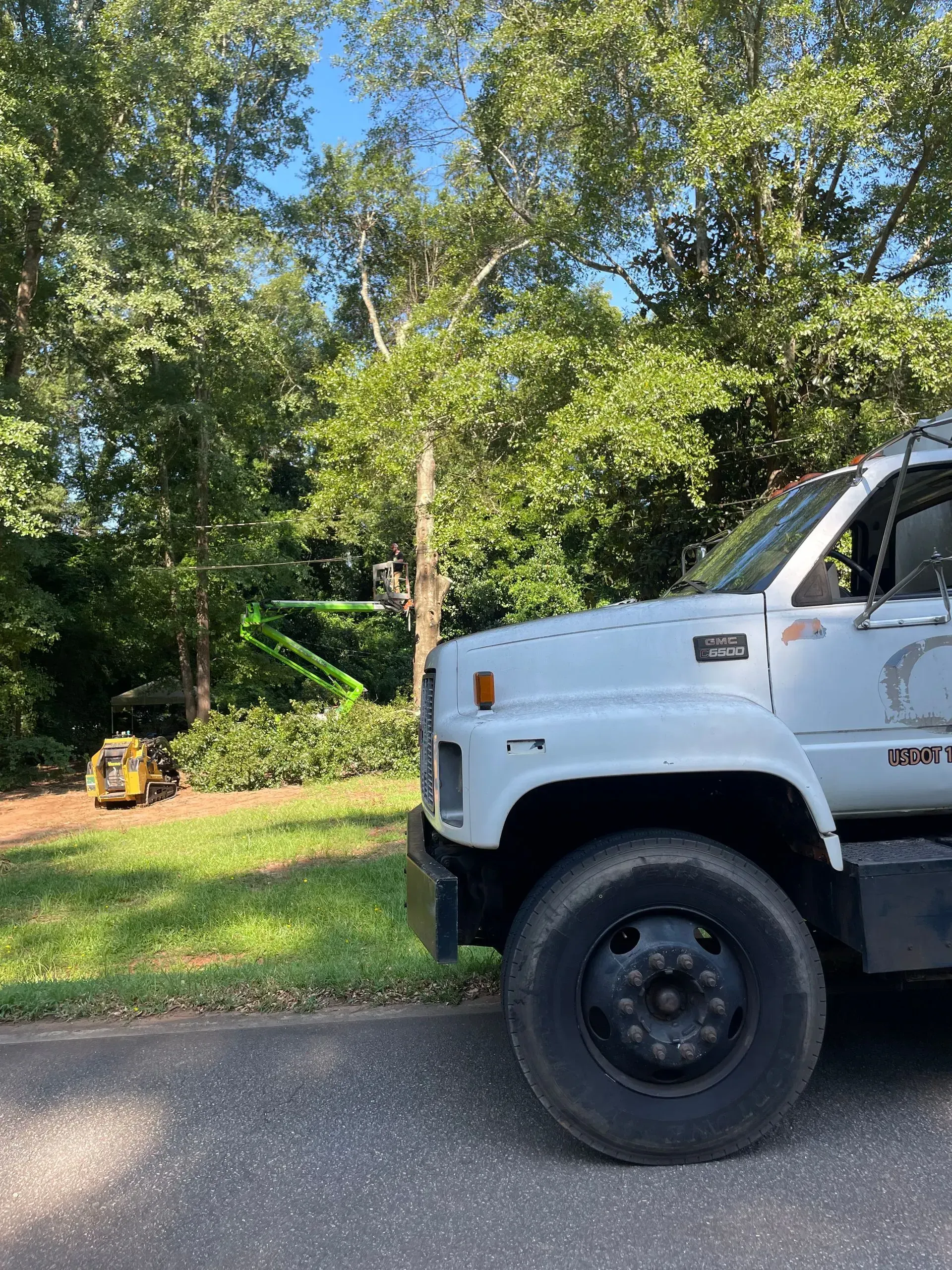 A white truck is parked on the side of the road.