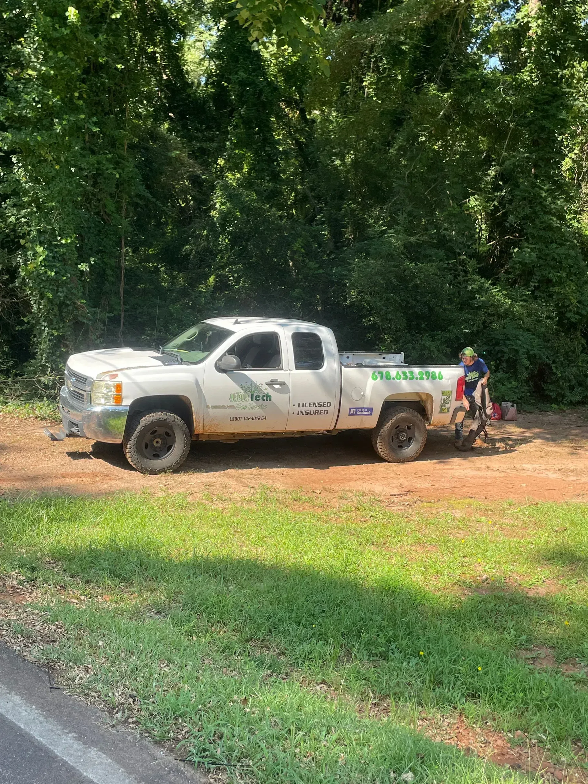 A white truck is parked on the side of the road.