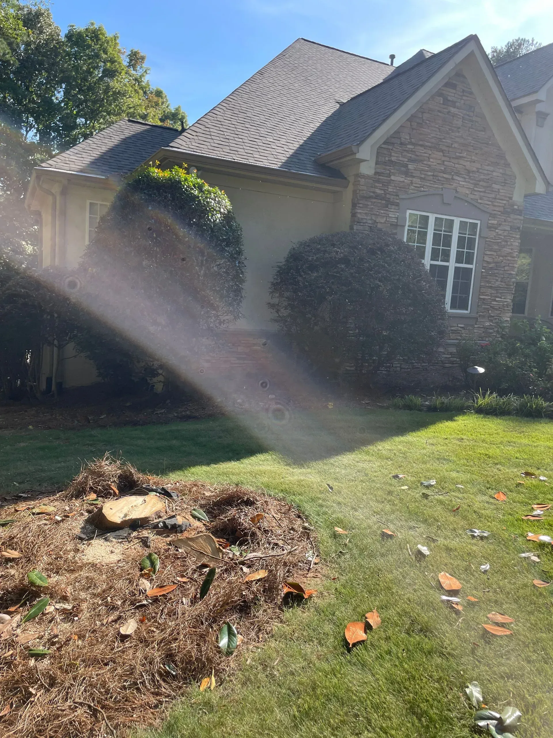 A house with a sprinkler in front of it.
