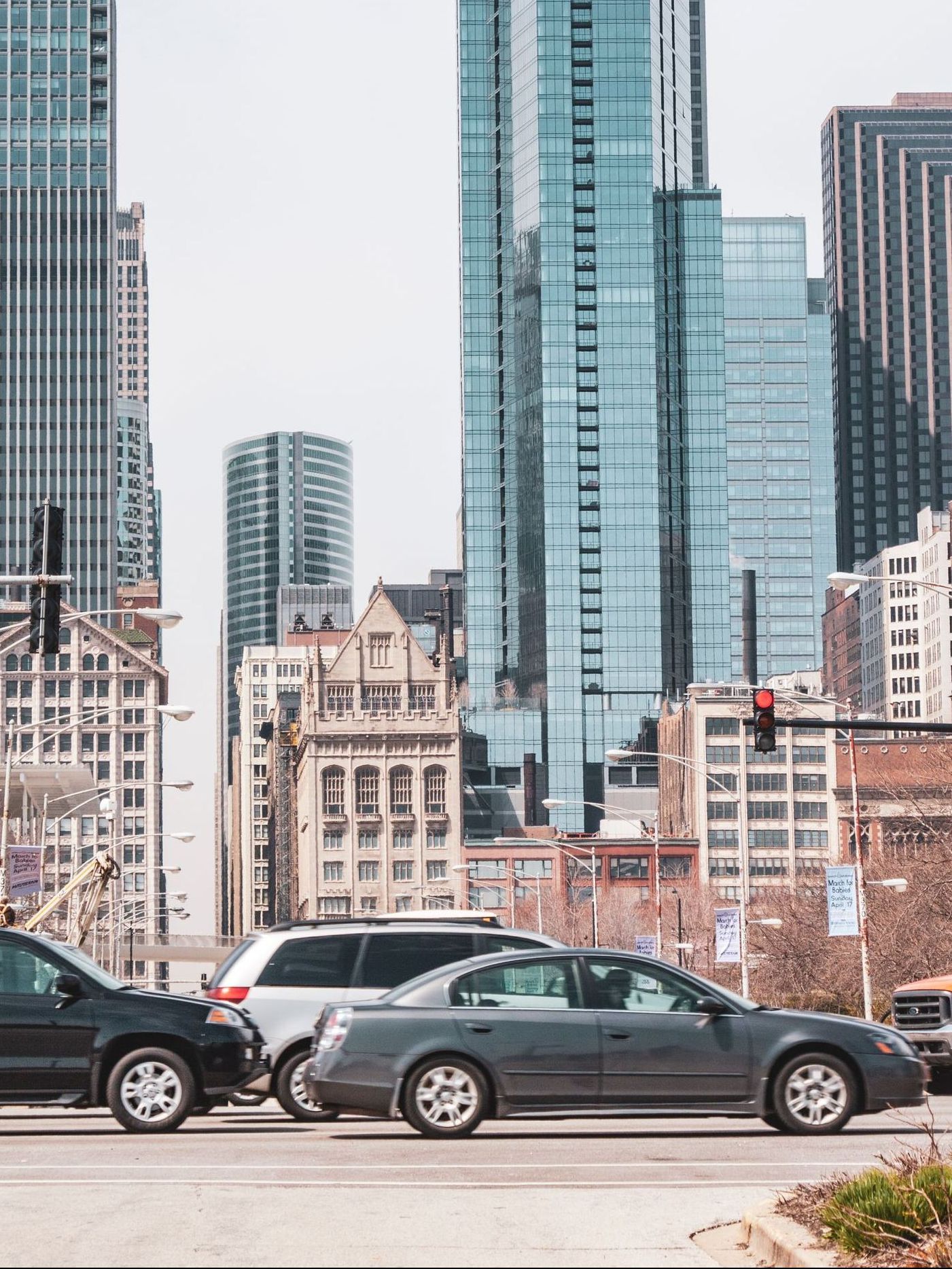A white suv is parked in a grassy field with its trunk open.