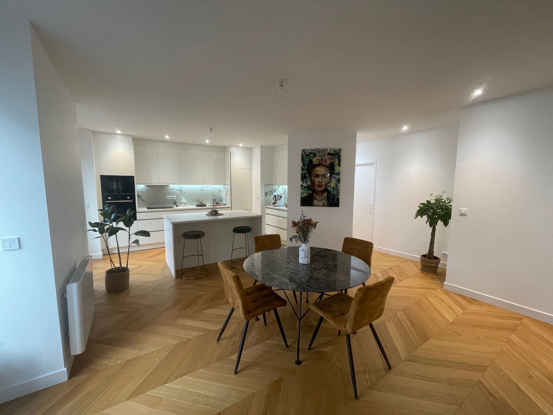 Il y a une table et des chaises au milieu de la pièce.