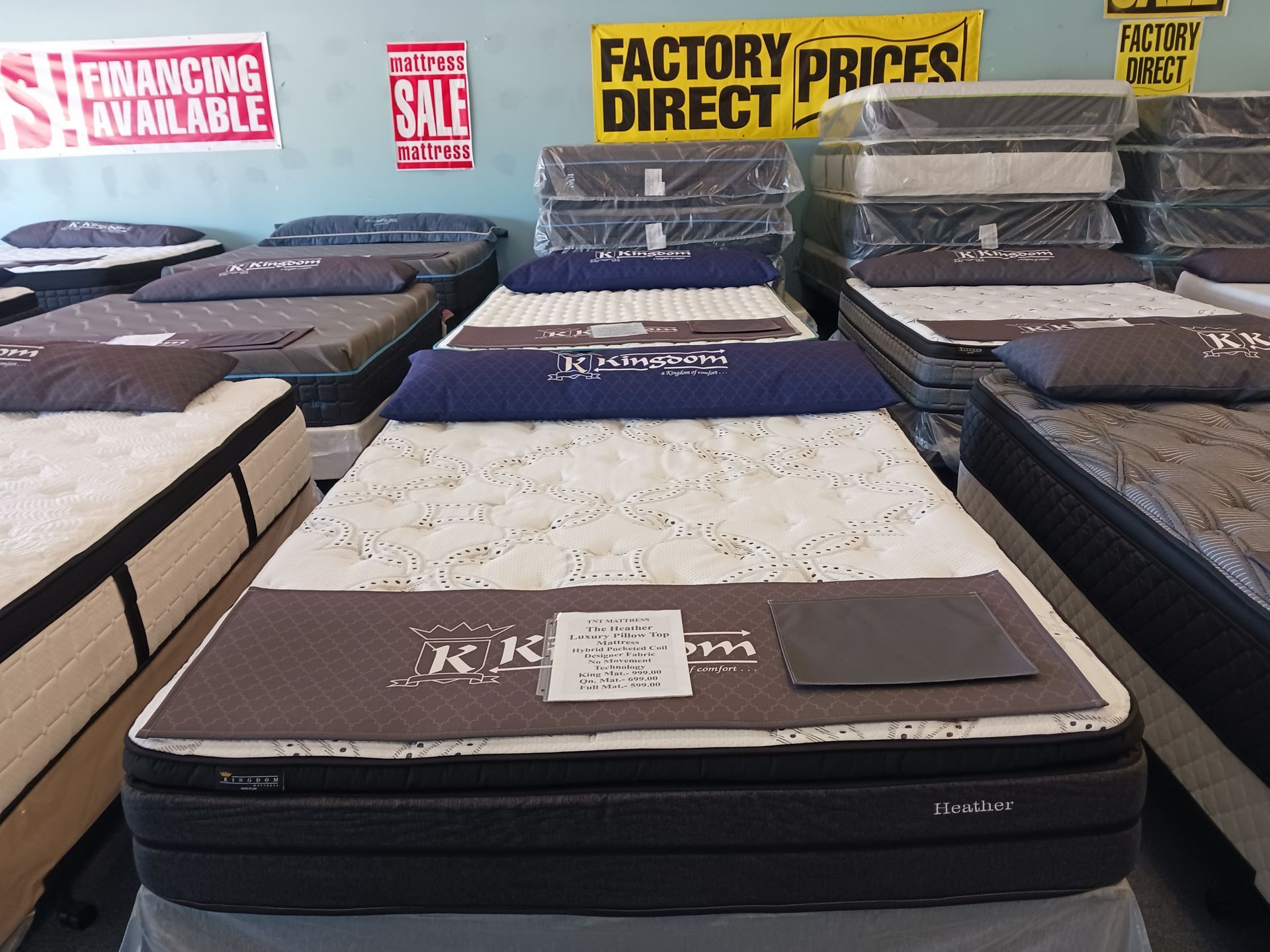 A mattress in a store with a sign that says factory direct