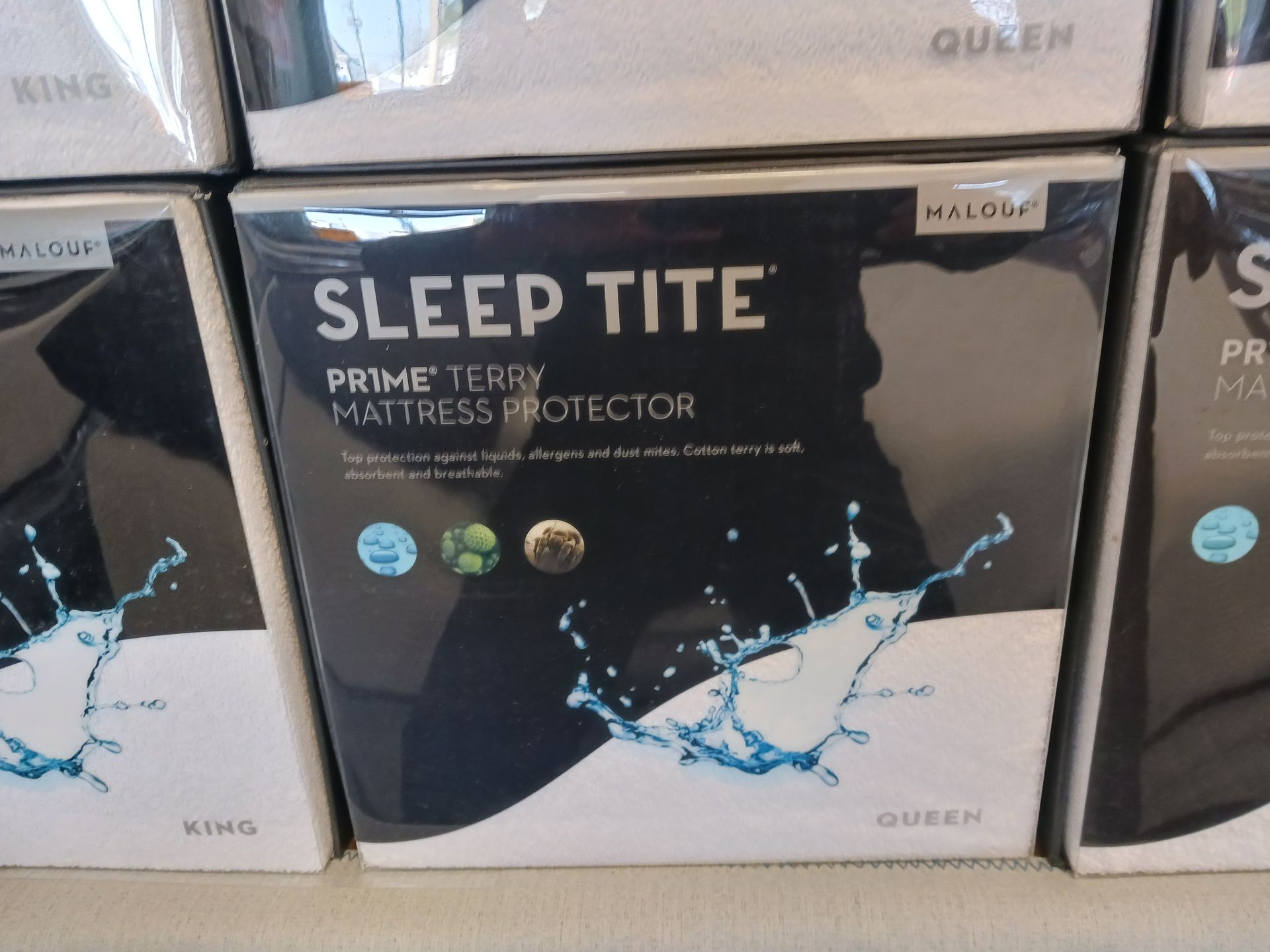 Boxes of sleep tite mattress protectors are stacked on top of each other