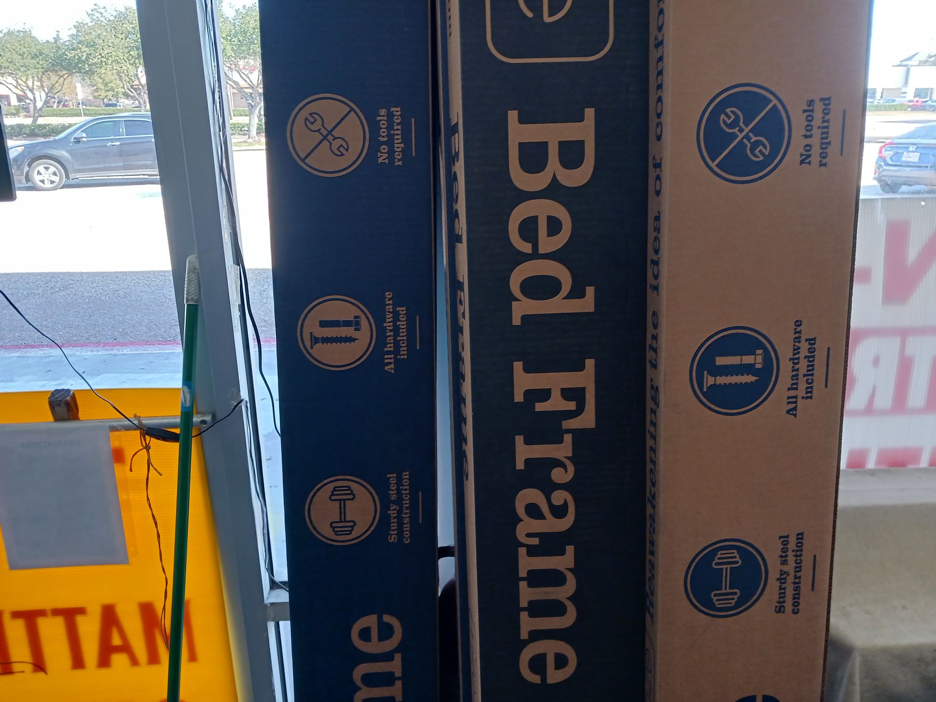 Three boxes of bed frames are stacked on top of each other