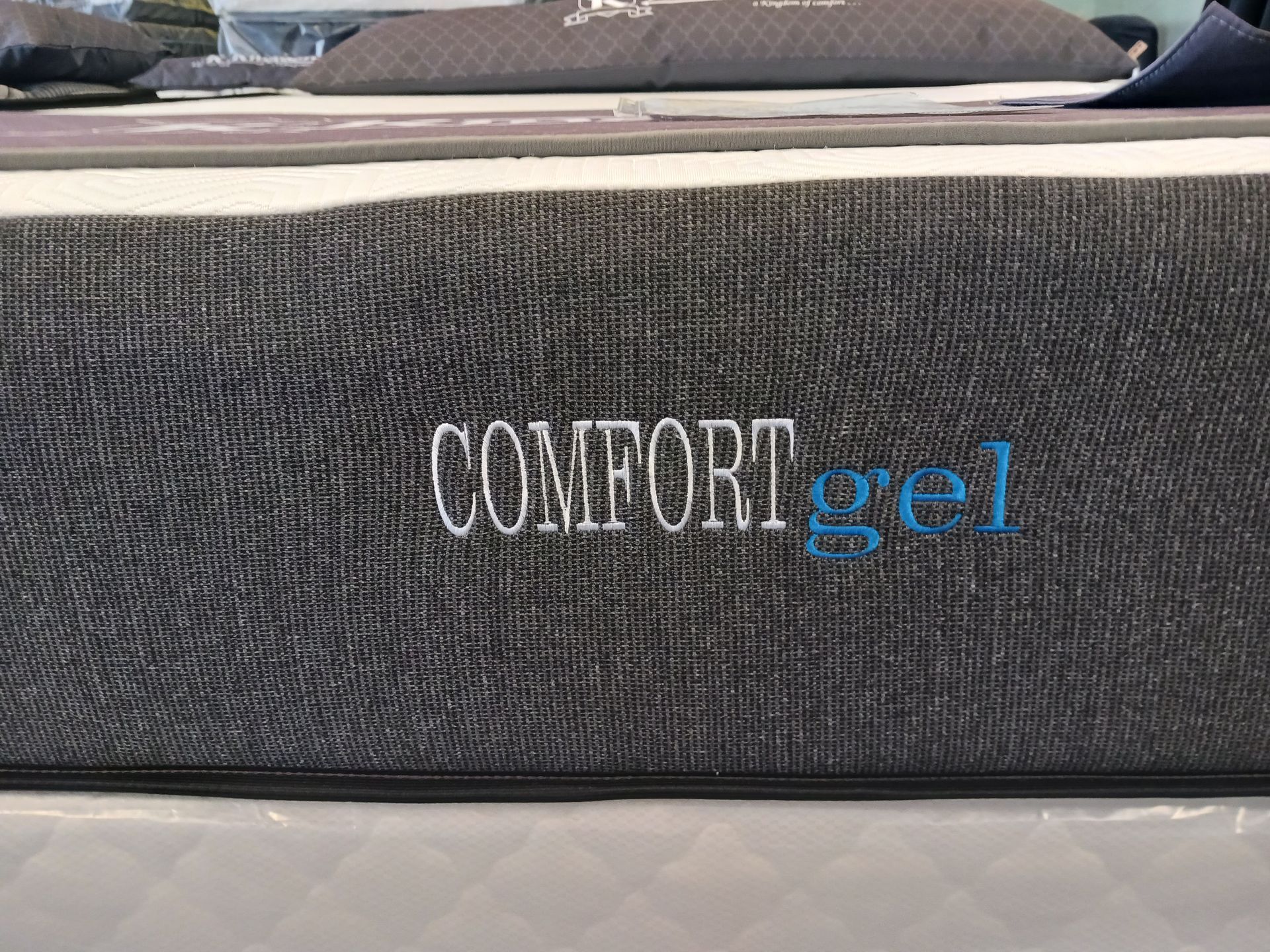 A comfort gel mattress is sitting on top of a bed.