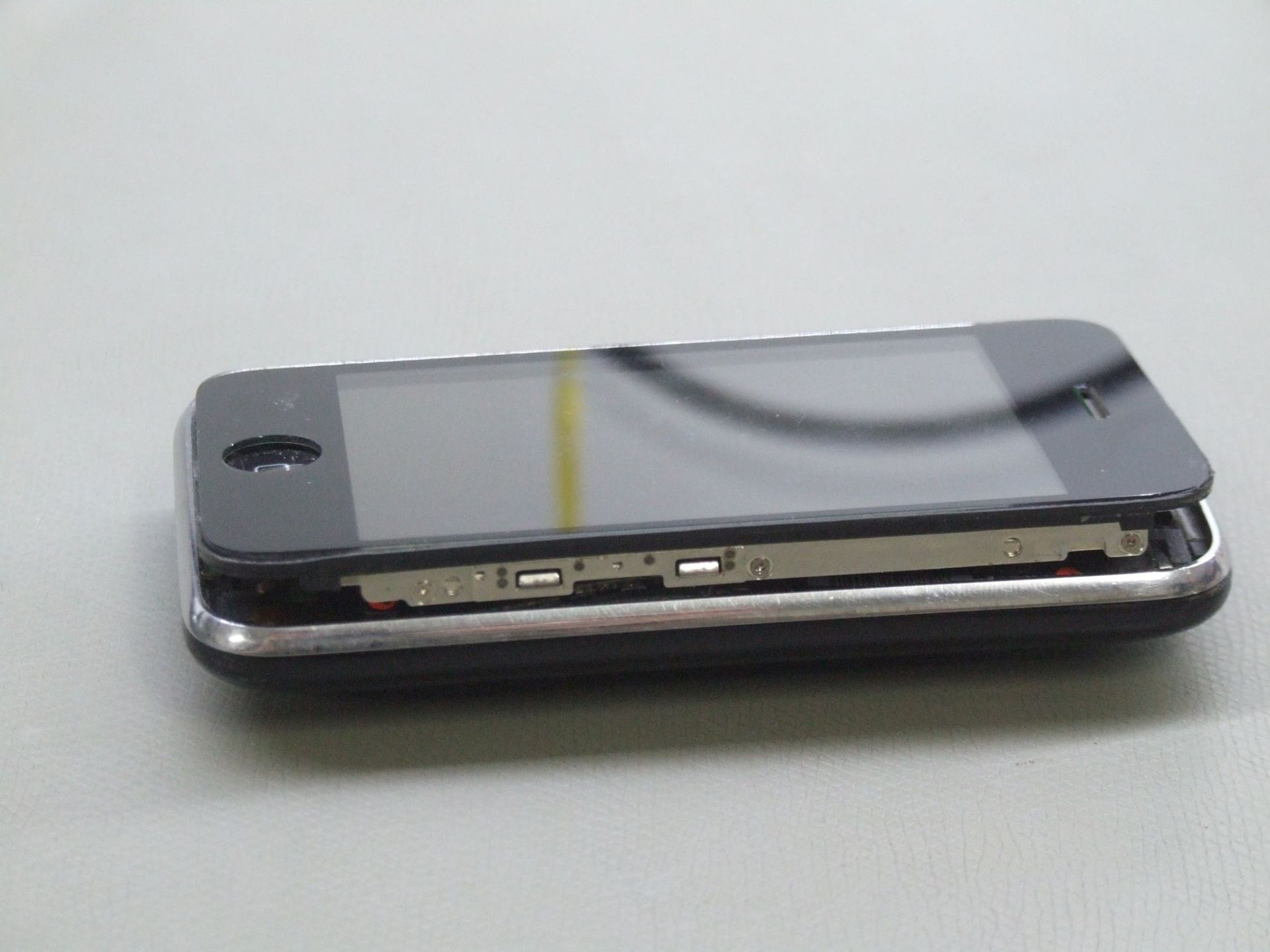 A Disassembled Black iPhone with The Screen Detached — Rescuetech Computer And iPhone Repairs in Ballina, NSW