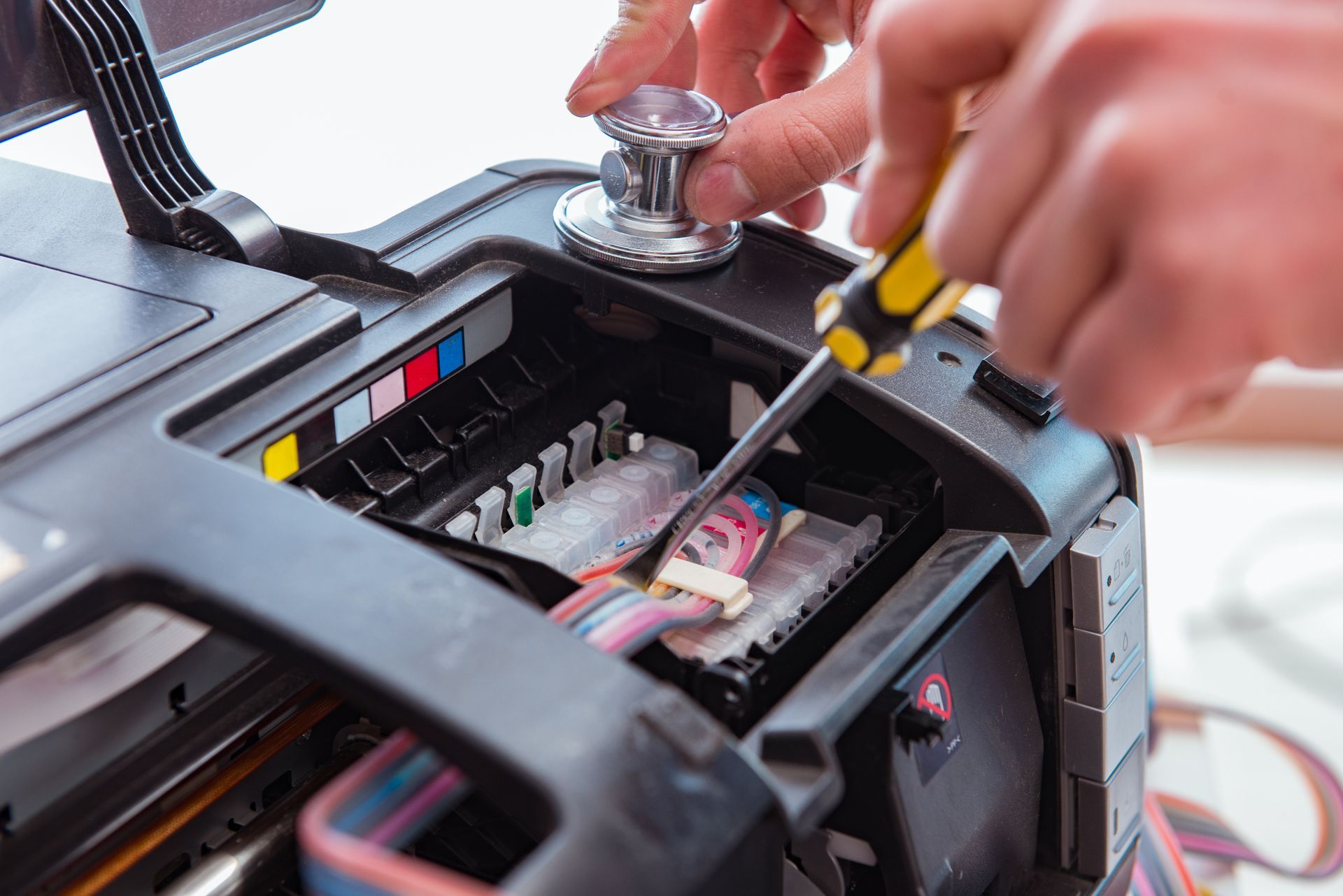 Hands Repairing a Printer Using a Screwdriver and Tool — Rescuetech Computer And iPhone Repairs in Ballina, NSW
