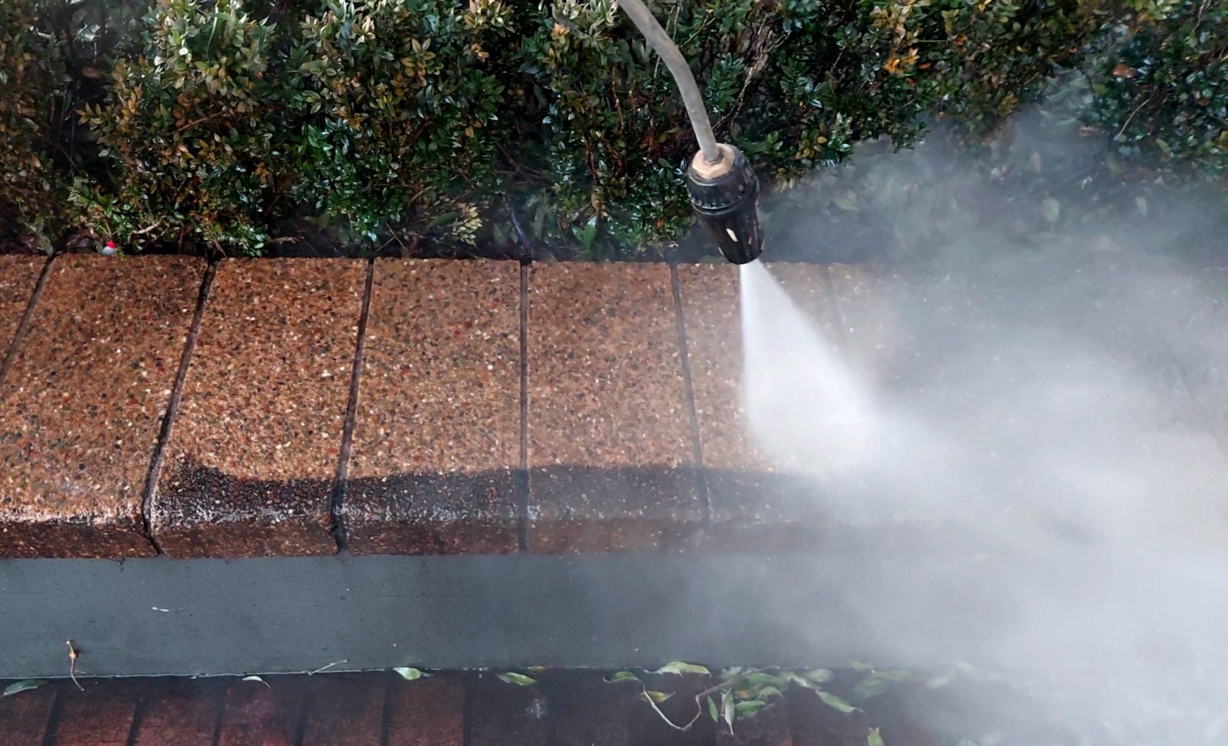 Pressure Cleaning Pebblecrete Garden Bed.