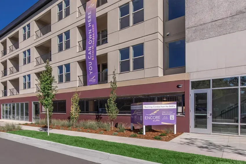 Modern apartment building with a sign that says 