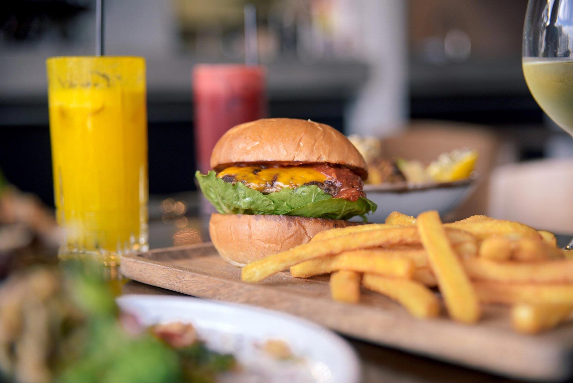 Koji Burger With A Side Of Fries And A Glass Of Freshly Squeezed Juice — Cafe, Bar and Catering Services in Southport, QLD
