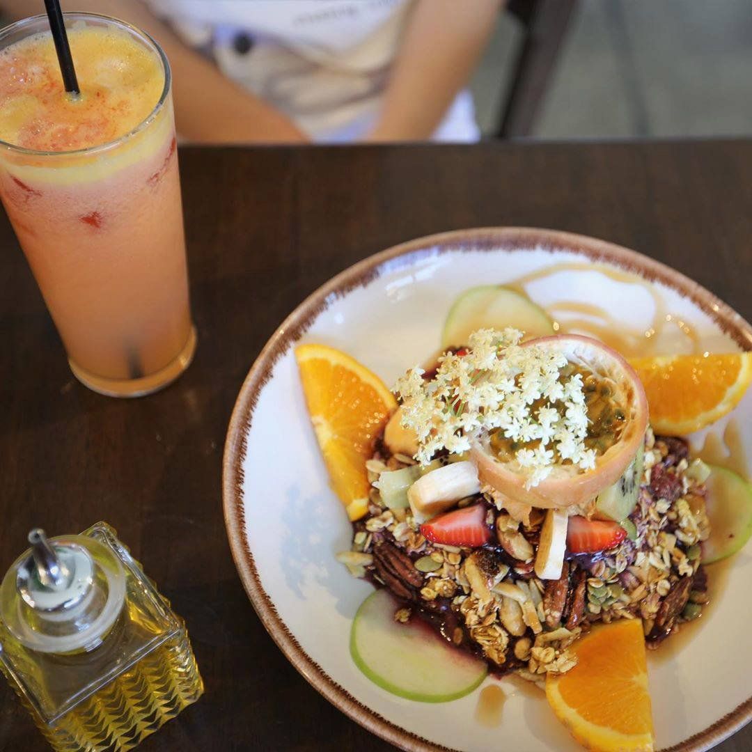 Glass Of Fresh Juice And A Dish With Different Fruits — Cafe, Bar and Catering Services in Southport, QLD