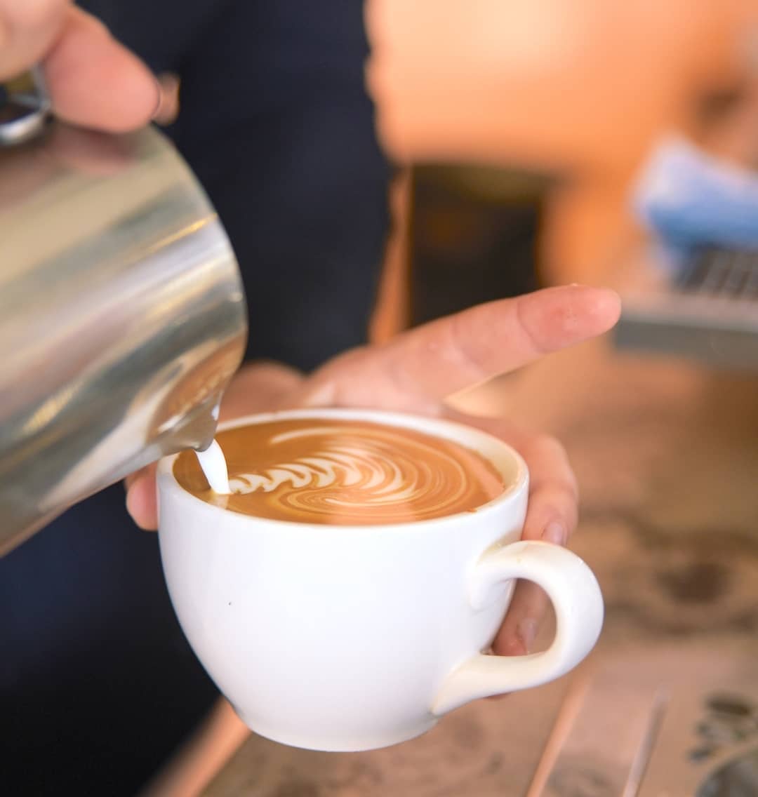 Barista Making Coffee Art  — Cafe, Bar and Catering Services in Southport, QLD