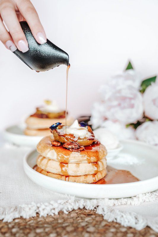 Maple Syrup Being Poured Over a Stack of Fluffy Pancakes — Cafe, Bar and Catering Services in Southport, QLD