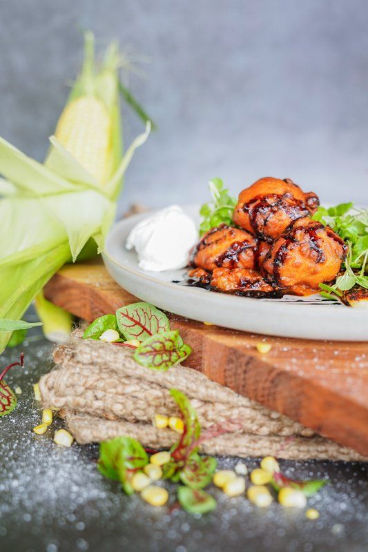 Corn Fritters With a Poached Egg and Salad — Cafe, Bar and Catering Services in Southport, QLD