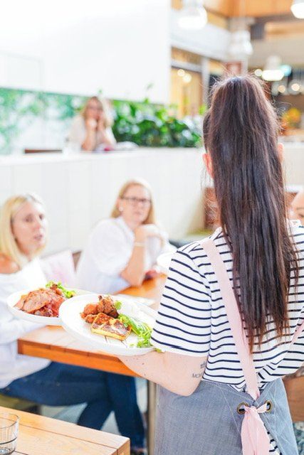 Waitress Serving Meals — Cafe, Bar and Catering Services in Southport, QLD