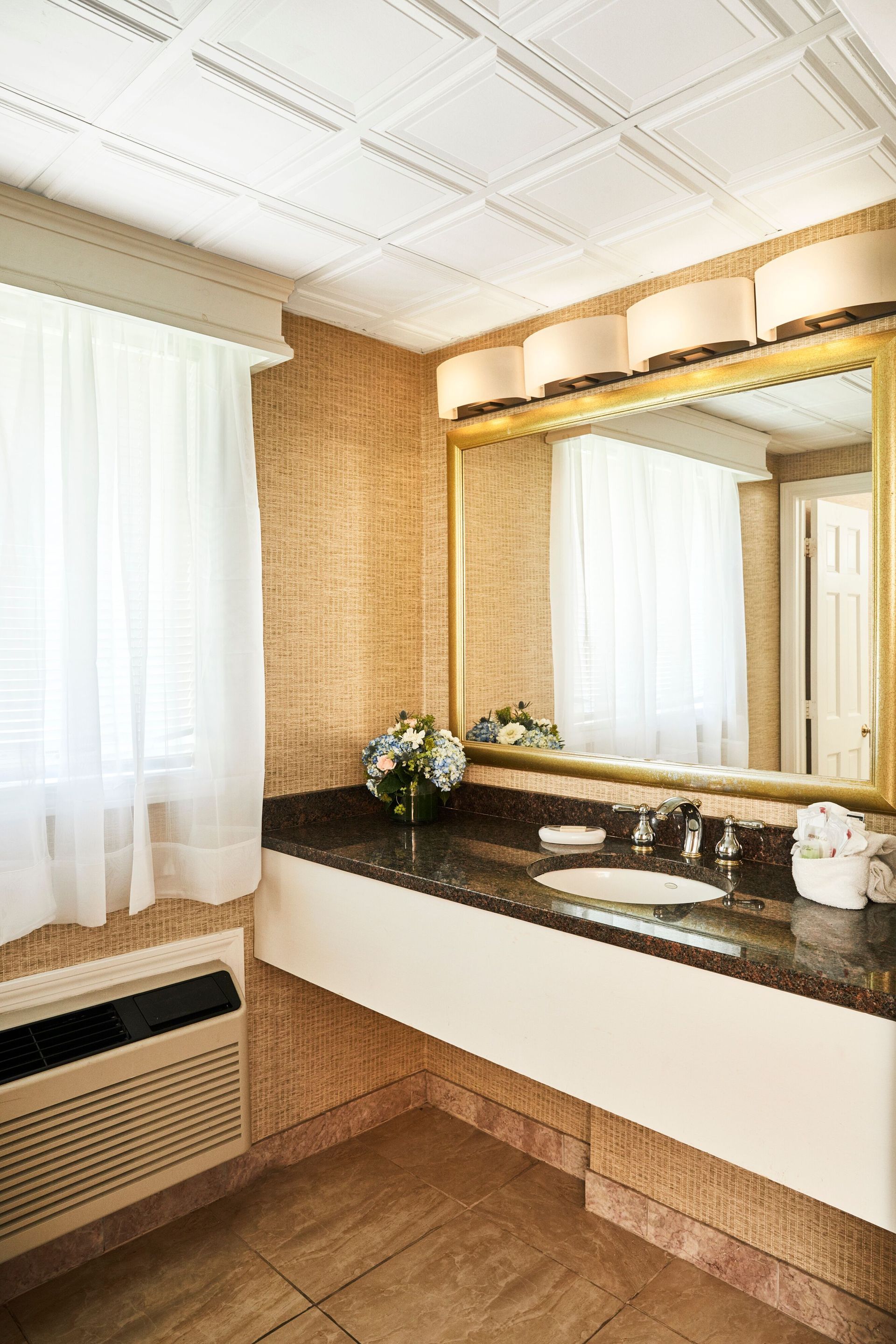 A bathroom with a sink and a large mirror