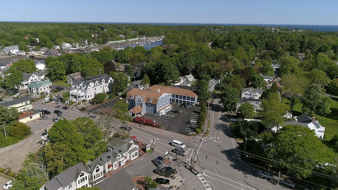 An aerial view of a small town with lots of trees and houses.