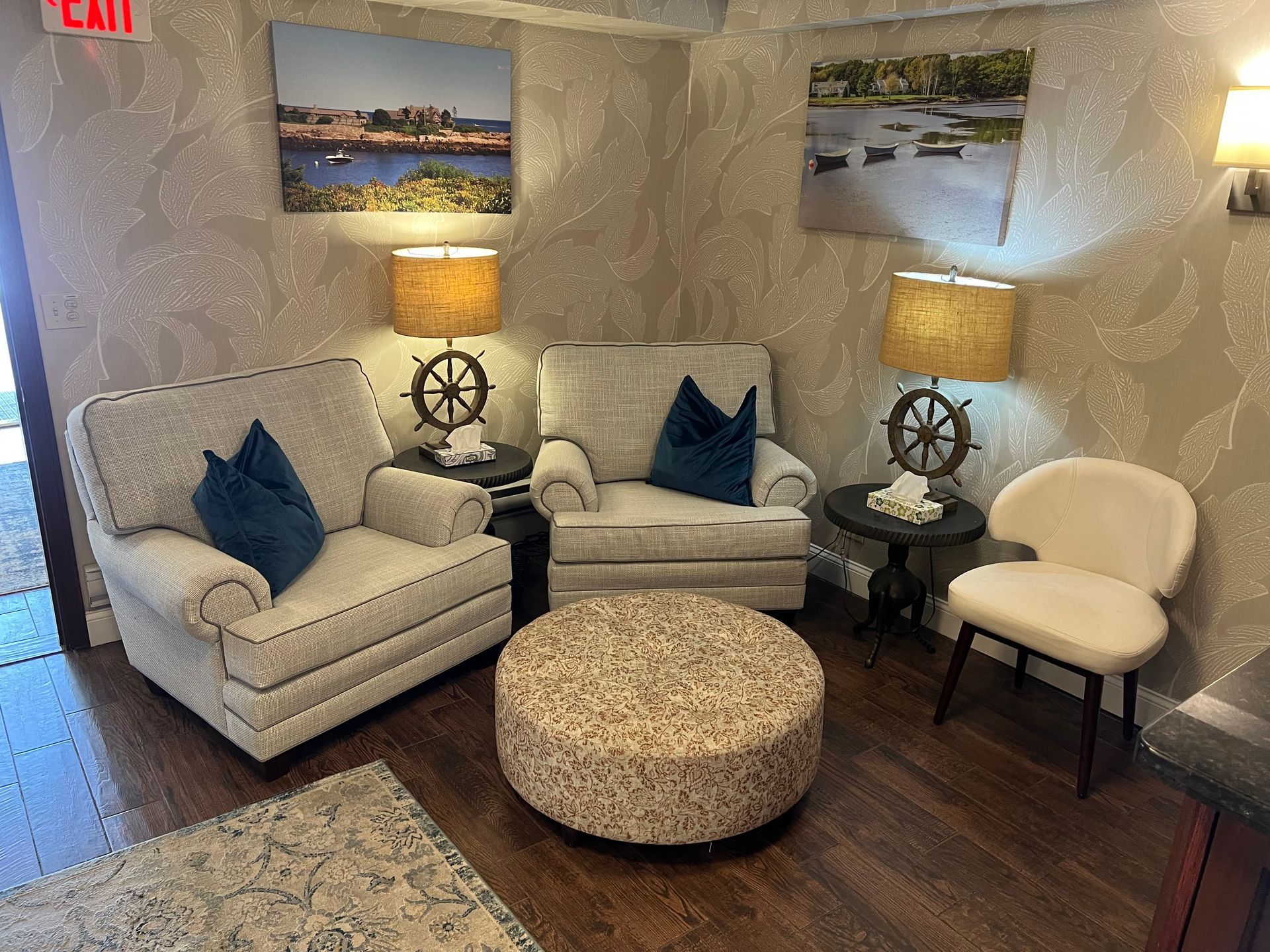 There are two chairs and an ottoman in the room.