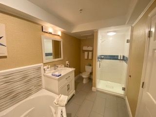 A bathroom with a sink , toilet , shower and bathtub.