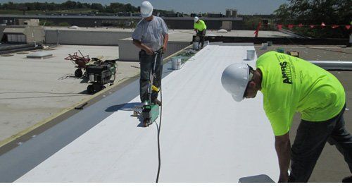 Commercial Roof — Contractor Paving The Roof in Evansville, IN