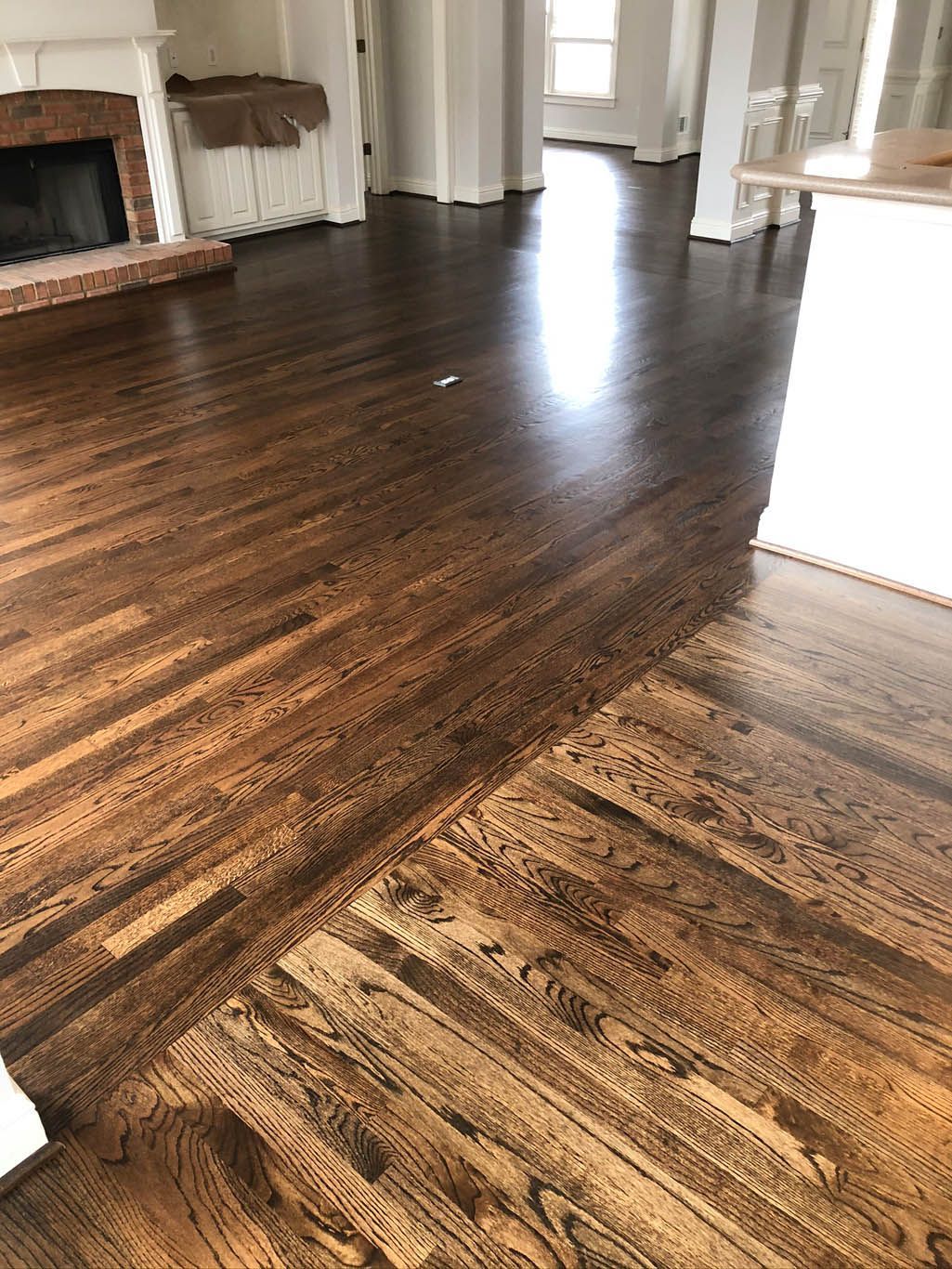 A living room with hardwood floors and a fireplace.