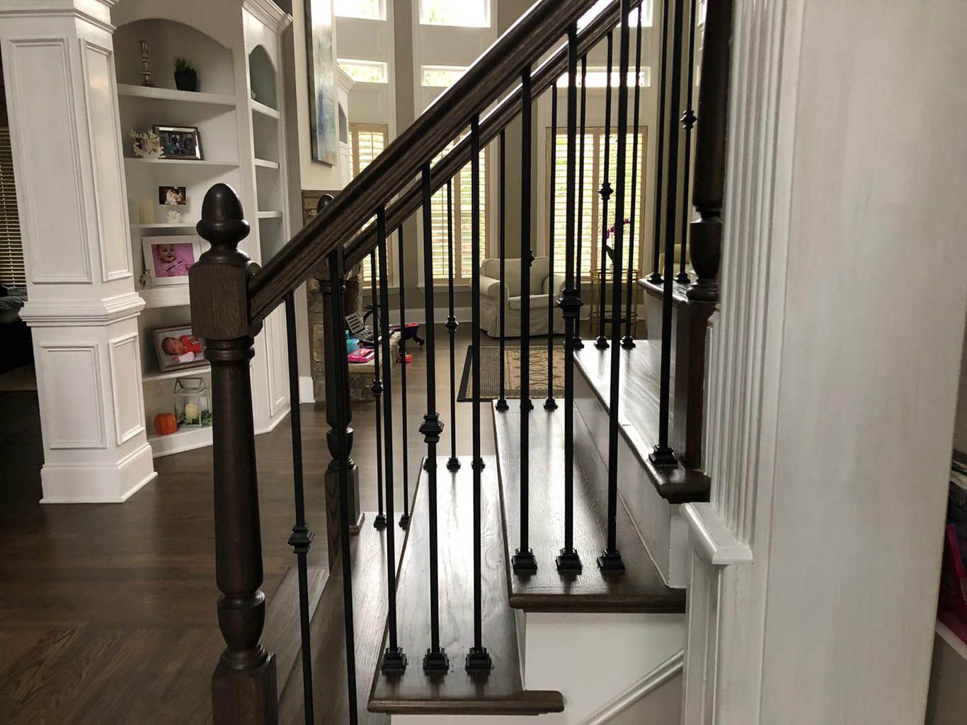 A staircase leading up to a living room in a house.