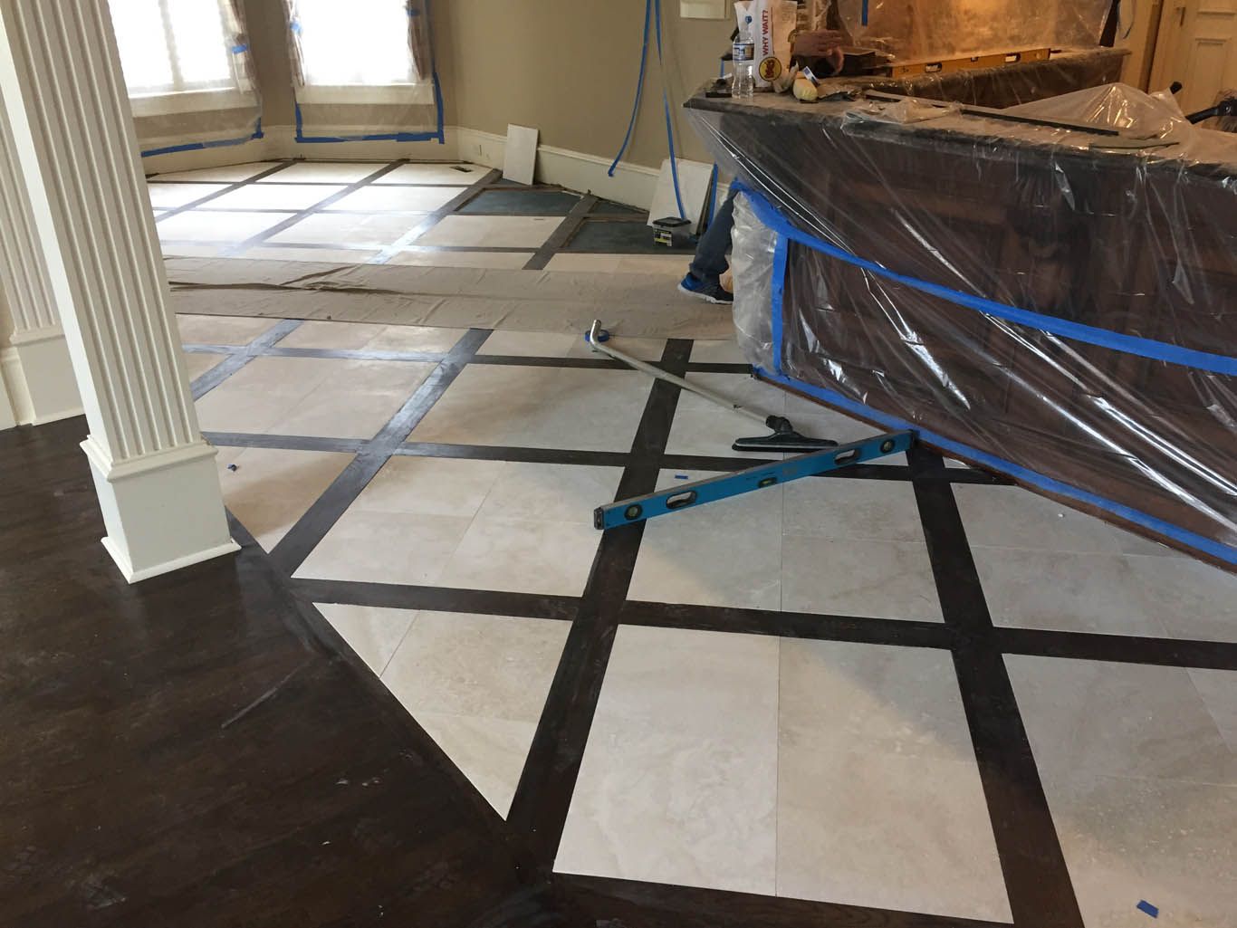 A room with a black and white tile floor and a counter in the background