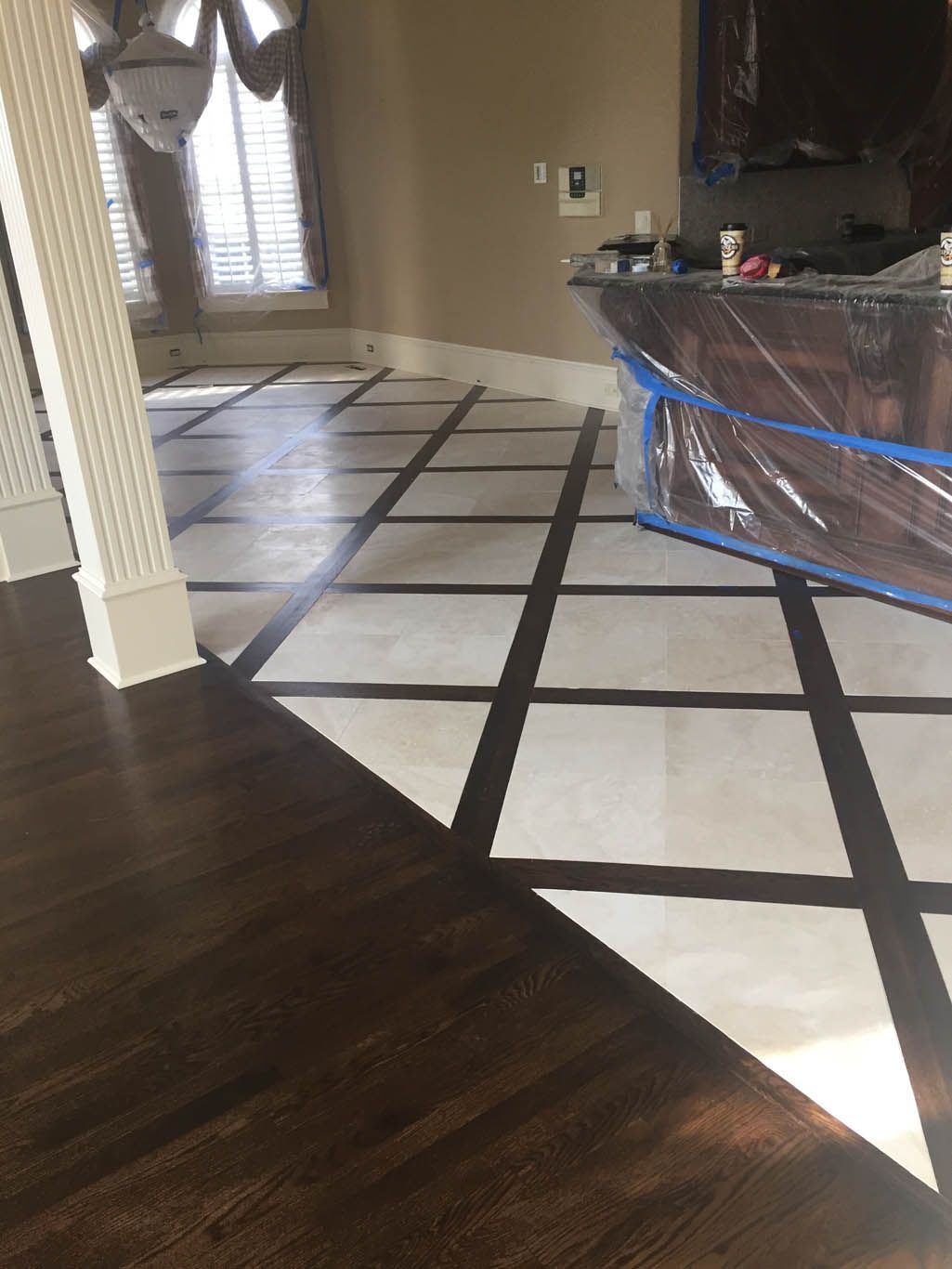A room with a wooden floor and a white tile floor.