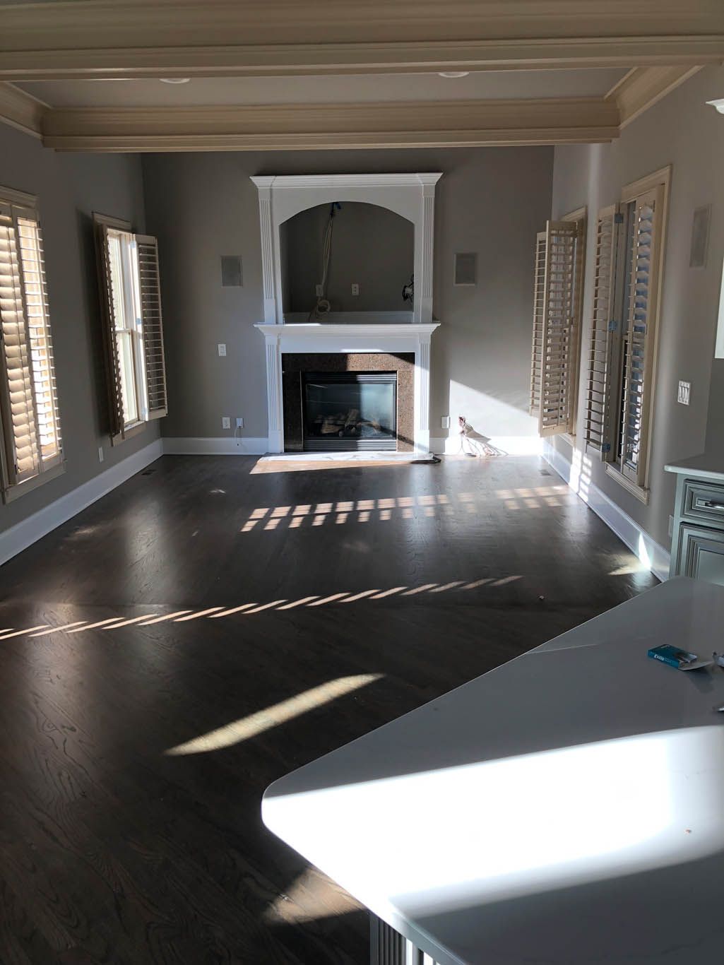 A living room with a fireplace and lots of windows