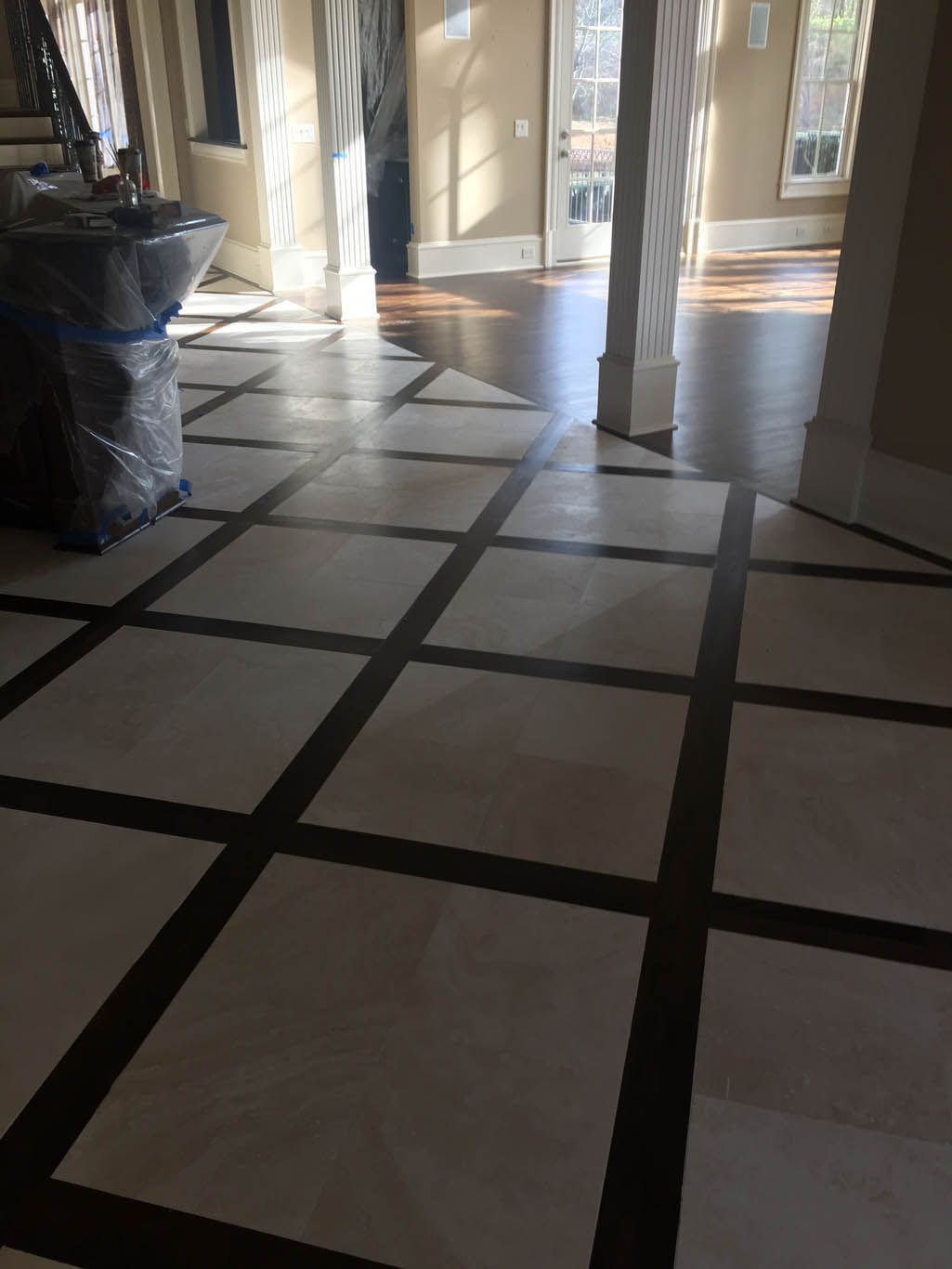 A room with a tiled floor and a wooden floor