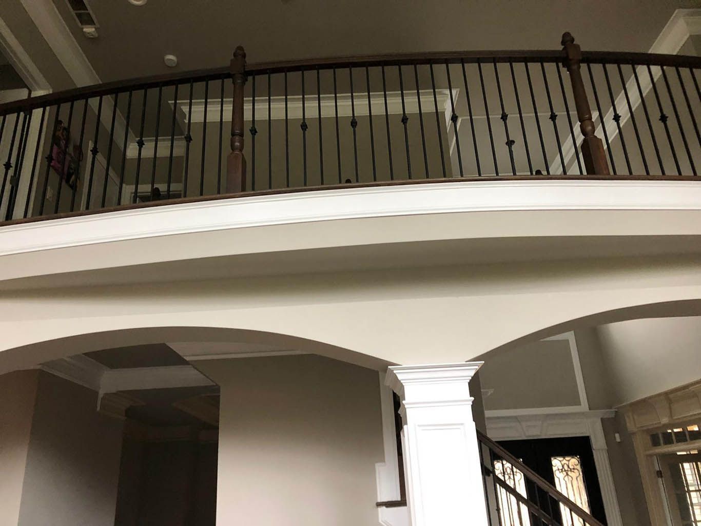 A balcony with a wrought iron railing in a house
