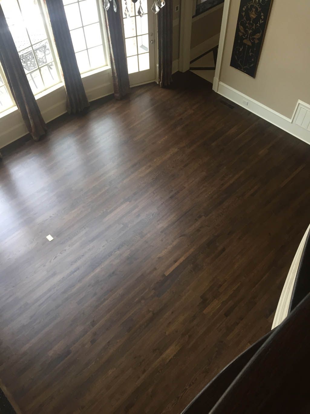 An aerial view of a living room with hardwood floors and a staircase.