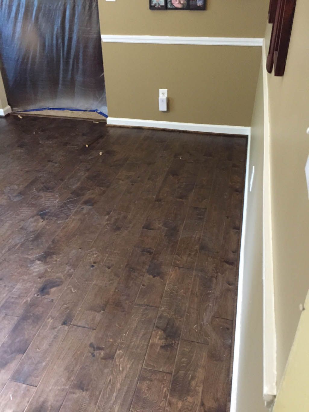 A room with a wooden floor and tan walls