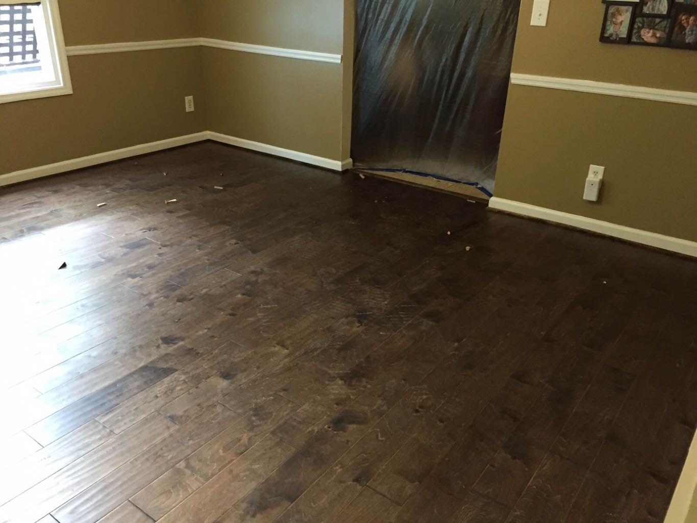 A living room with hardwood floors and beige walls