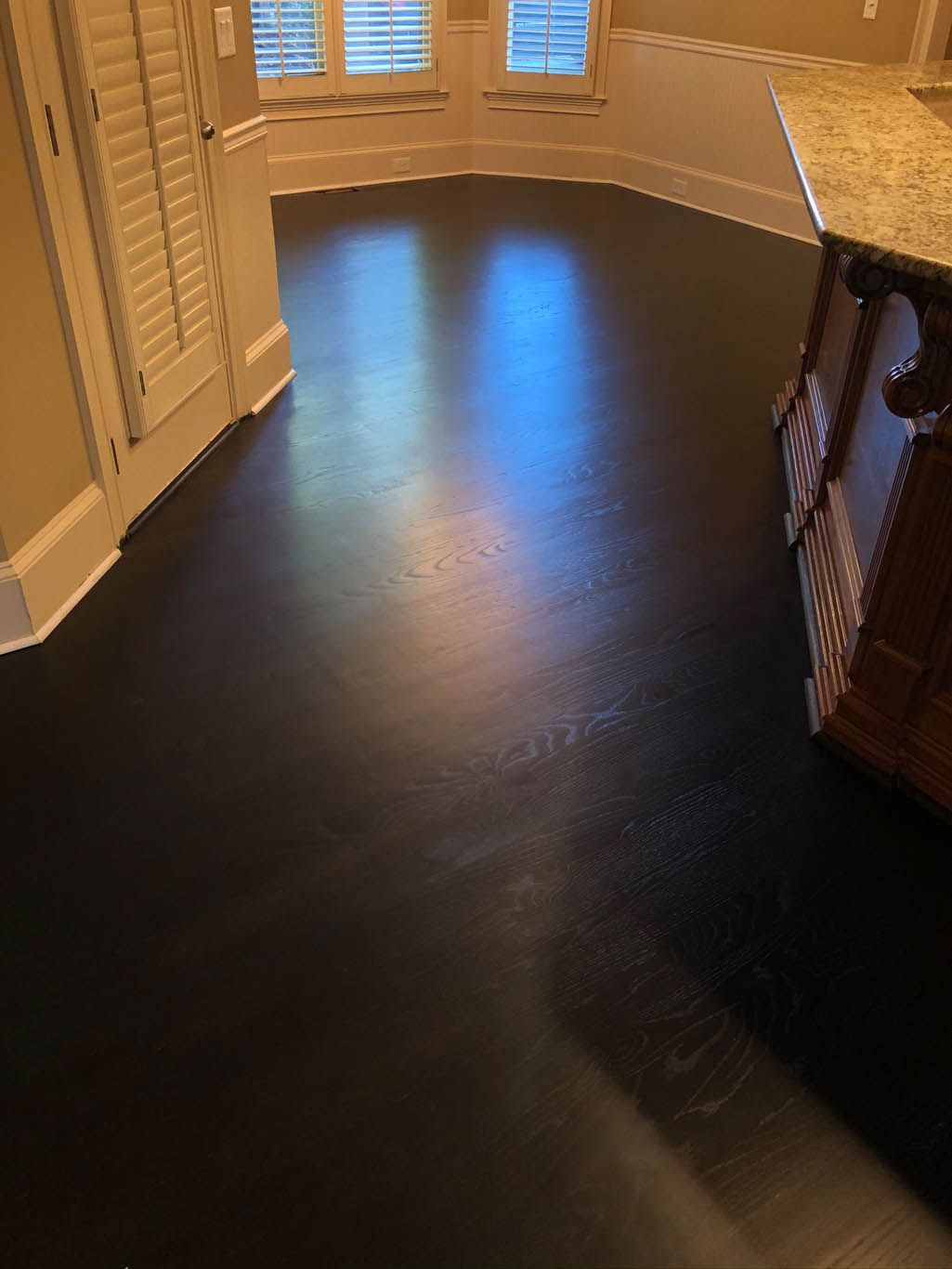 A kitchen with a black floor and a sink.