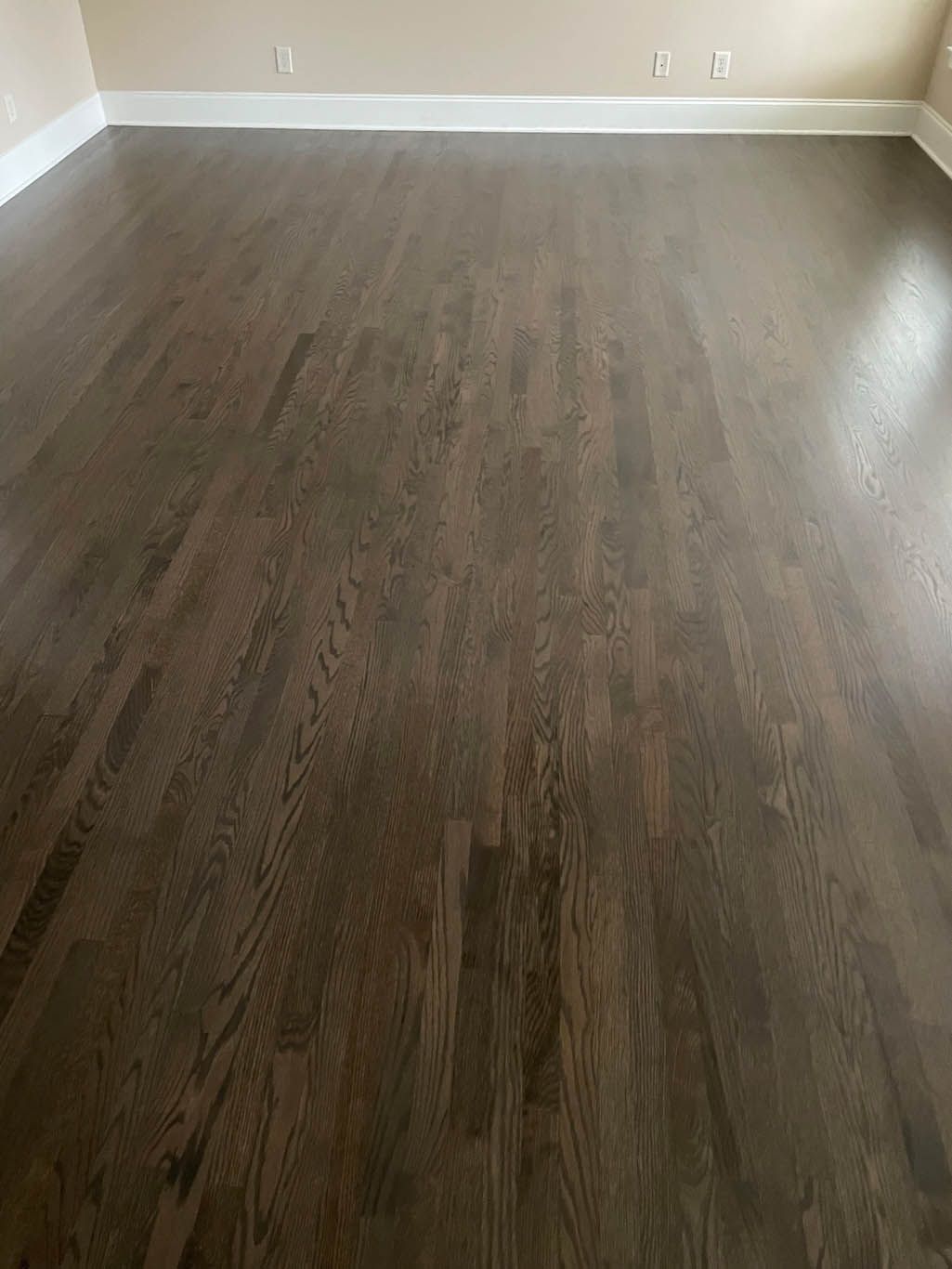 A living room with hardwood floors and white trim.