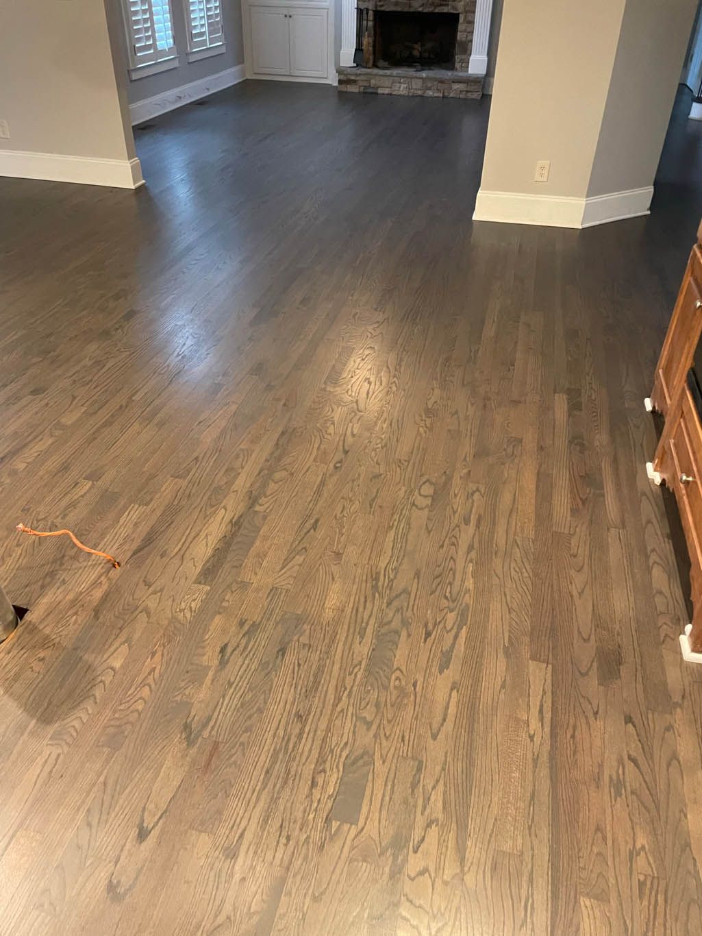 A living room with hardwood floors and a fireplace.