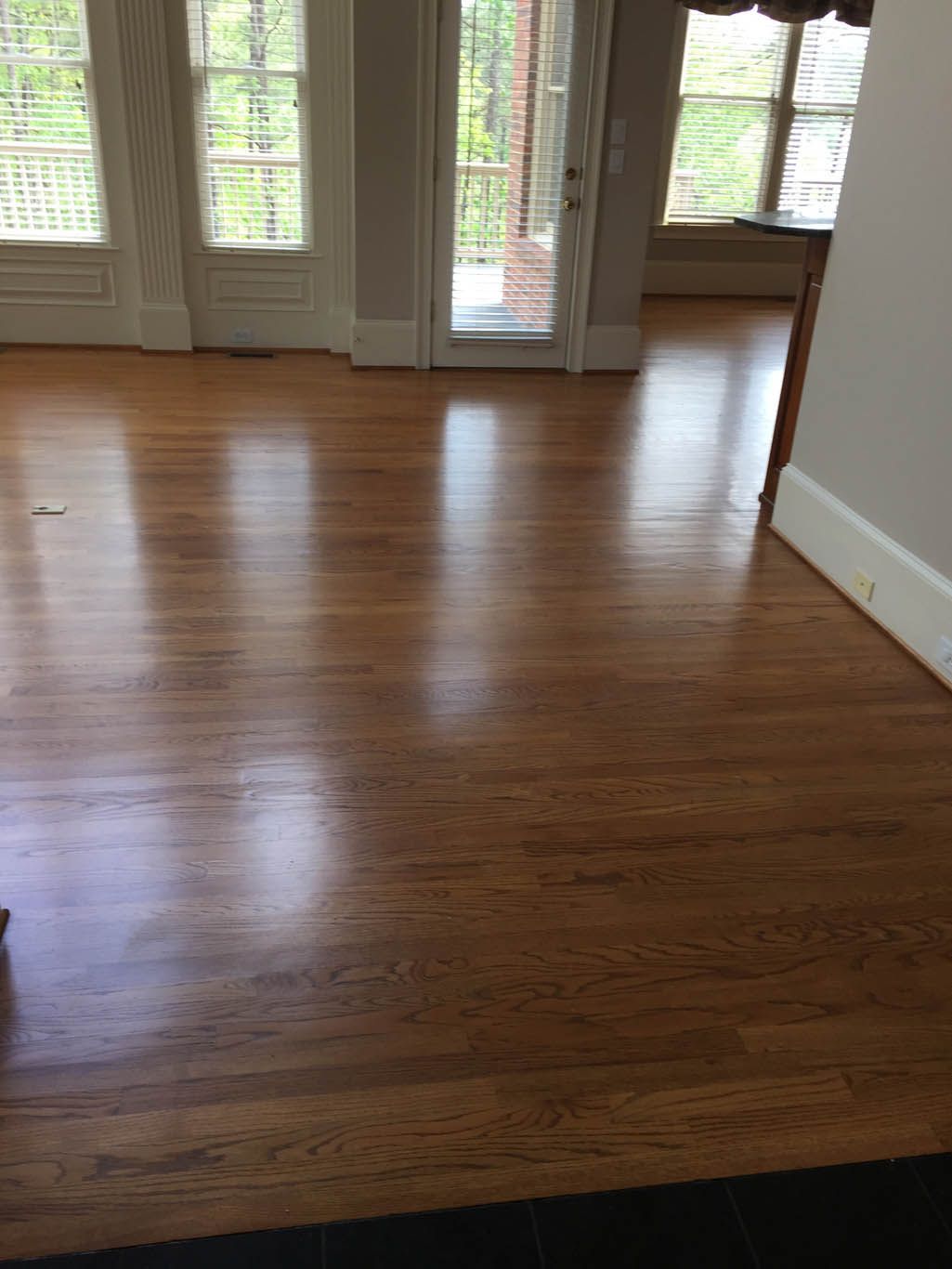 A living room with hardwood floors and a sliding glass door.