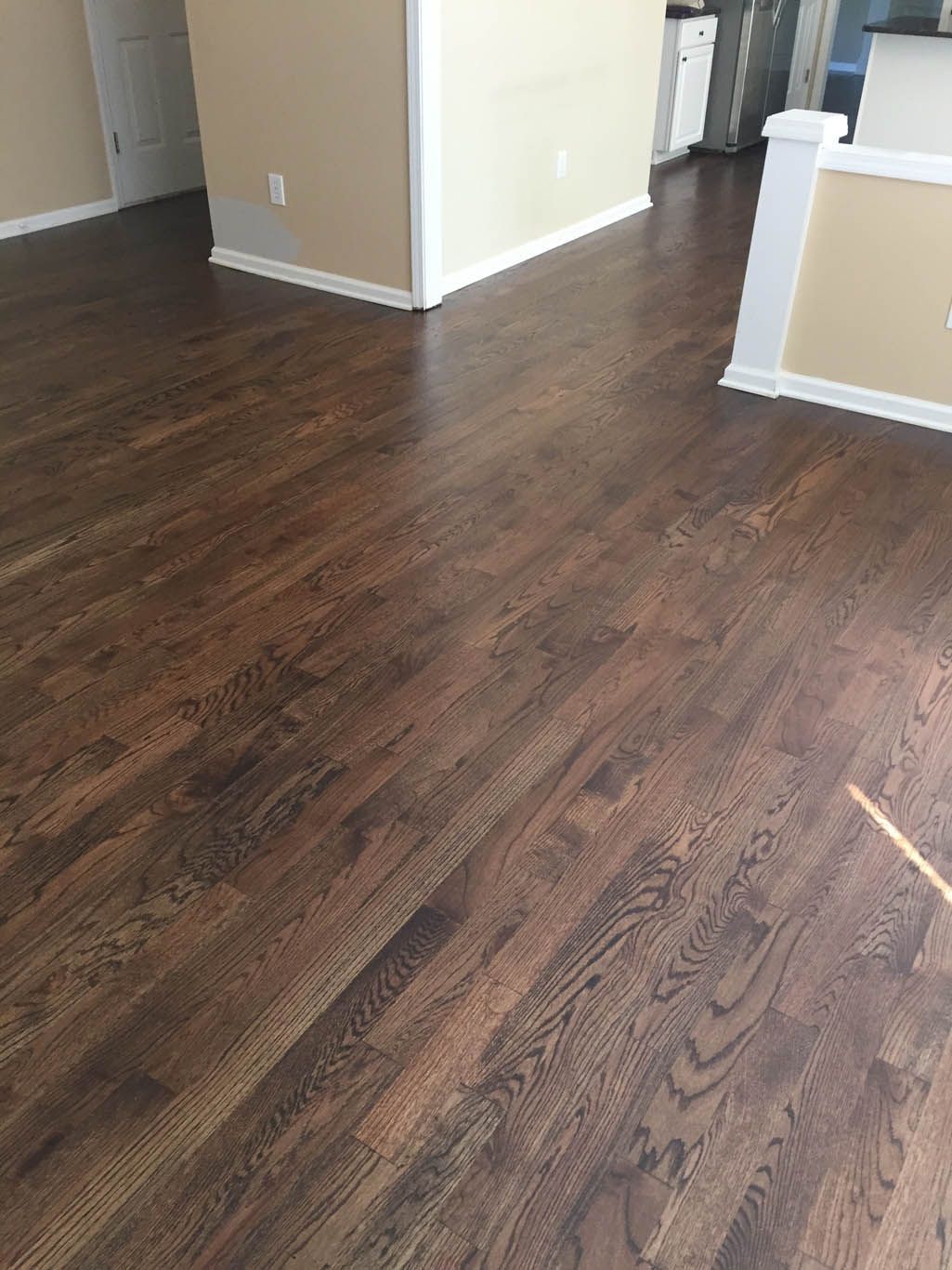 A living room with hardwood floors and beige walls.