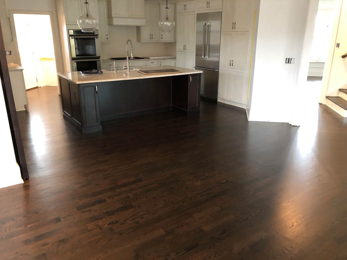A kitchen with a large island and stainless steel appliances
