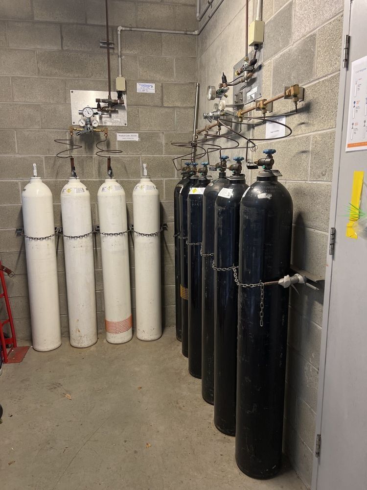 A Room Filled With Lots Of Gas Cylinders — Advantage Plumbing Solutions In Gateshead, NSW